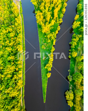 Aerial view captures the merging of the Vltava and Labe rivers by Melnik. Lush greenery surrounds the waterways, showcasing nature's beauty at this serene location. Aerial view captures the merging of the Vltava and Labe rivers by Melnik. Lush greenery surrounds the waterways, showcasing nature's beauty at this serene location. 126391898