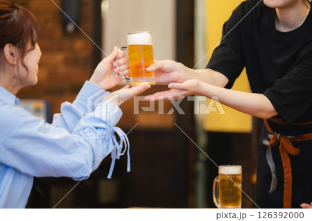 飲食店でビールを運ぶホールスタッフ 126392000