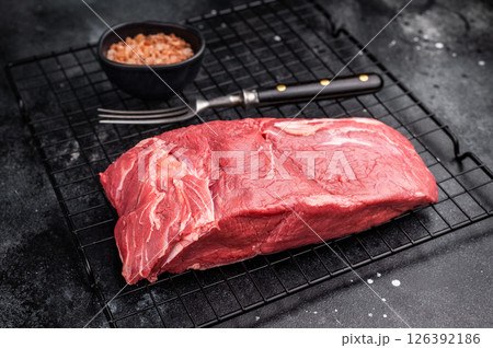 Close-up of raw horse meat, emphasizing its quality and freshness, ready to be transformed into exquisite dishes for adventurous palates. black background. top view Close-up of raw horse meat, emphasizing its quality and freshness, ready to be transformed into exquisite dishes for adventurous palates. black background. top view 126392186