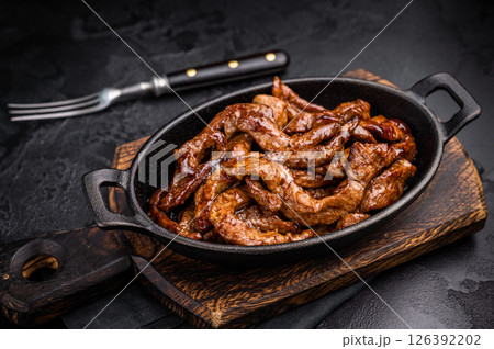 Korean Beef Meat Bulgogi Hot Plate. black background. top view 126392202