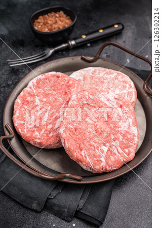 Frozen Meat cutlet, mincemeat of pork and beef for burgers. black background. top view 126392214