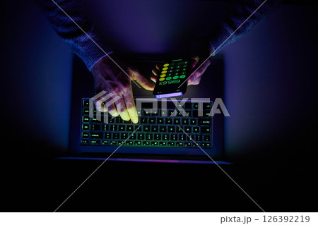 Male hands are using calculator on mobile phone and laptop keyboard. Male hands are using calculator on mobile phone and laptop keyboard. 126392219