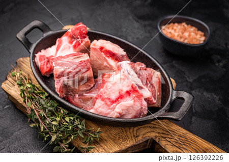 Raw chopped lamb meat with bones, uncooked mutton ready for cooking. black background. top view 126392226