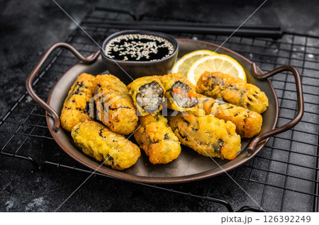 Crispy seaweed noodle rolls Gimmari, Korean deep fried seaweed rolls. black background. top view Crispy seaweed noodle rolls Gimmari, Korean deep fried seaweed rolls. black background. top view 126392249