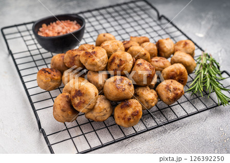 Fried Meatballs from beef and pork minced meat garnished with fresh herbs. grey background. top view Fried Meatballs from beef and pork minced meat garnished with fresh herbs. grey background. top view 126392250