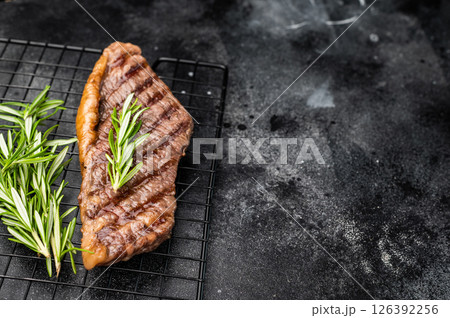 Grilled Brazilian picanha, rump cap beef steak. black background. top view Grilled Brazilian picanha, rump cap beef steak. black background. top view 126392256