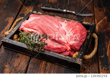 Unccoked Top Round beef, raw topround roast meat with thyme. wooden background. Top view Unccoked Top Round beef, raw topround roast meat with thyme. wooden background. Top view 126392258