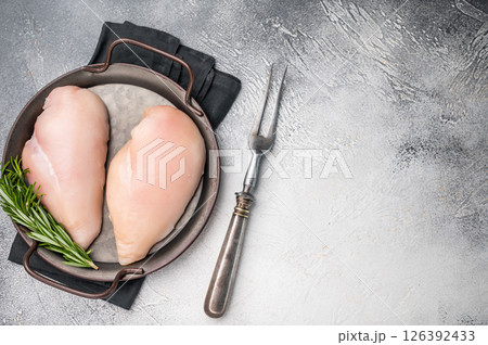 Raw poultry fillets, ready to be seasoned and cooked. These versatile cuts are ideal for grilling, baking, or stir-frying. white background. top view Raw poultry fillets, ready to be seasoned and cooked. These versatile cuts are ideal for grilling, baking, or stir-frying. white background. top view 126392433