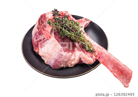 Fresh Tomahawk beef steak, raw marbled rib eye with bone on plate with herbs Isolated on a white background. top view 126392495