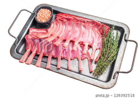 Raw mutton meat for chops steaks, uncooked rack of lamb on steel tray with herbs isolated on white background. top view 126392518