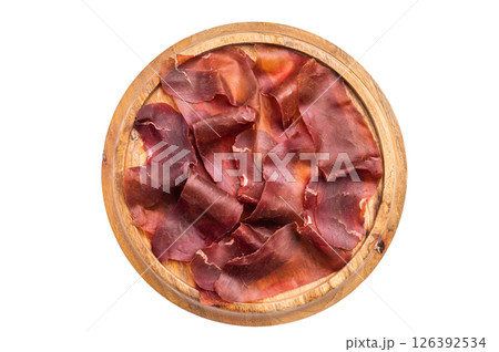 Cecina meat slices, spanish beef jamon on wooden tray isolated on white background. top view Cecina meat slices, spanish beef jamon on wooden tray isolated on white background. top view 126392534
