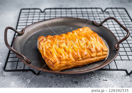 Danish pastry with a lemon jam, Puff pastry. grey background. top view Danish pastry with a lemon jam, Puff pastry. grey background. top view 126392535