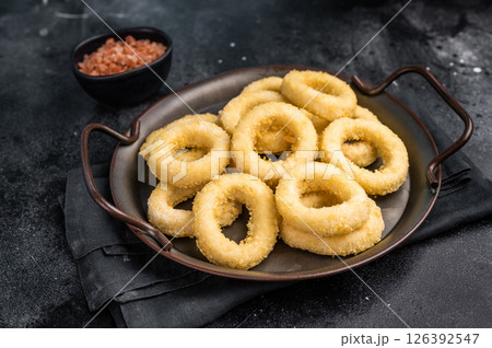Ready for cooking Raw onion rings, uncooked vegetable. black background. top view Ready for cooking Raw onion rings, uncooked vegetable. black background. top view 126392547