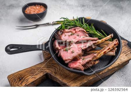 Roast lamb chops, mutton meat cutlets in a skillet. grey background. top view 126392564