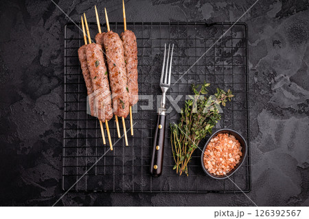 Grilled Cevapcici skewers, Cevapi sausages from mince beef and pork meat. black background. top view Grilled Cevapcici skewers, Cevapi sausages from mince beef and pork meat. black background. top view 126392567