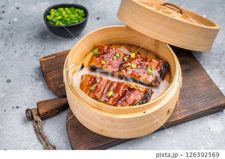 Unagi eel, Japanese grilled eel with sweet soy sauce. grey background. top view Unagi eel, Japanese grilled eel with sweet soy sauce. grey background. top view 126392569