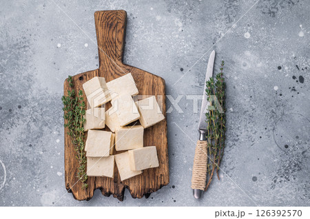 Organic Diced soy tofu cheese on wooden board. grey background. top view 126392570
