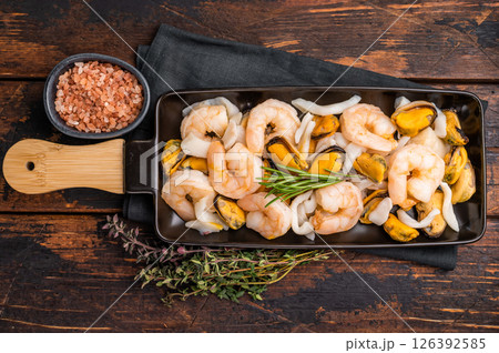 Seafood Cocktail appetiser with Mussels, Clams, Prawns, Shrimps and squid. wooden background. top view Seafood Cocktail appetiser with Mussels, Clams, Prawns, Shrimps and squid. wooden background. top view 126392585