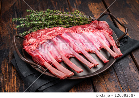 Fresh rack of lamb, raw mutton meat for chops steaks on steel tray. wooden background. top view 126392587