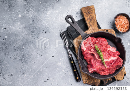 Ready for grilling Raw hanging tender or Hanger beef steak in a pan. grey background. top view 126392588