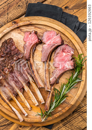 Grilled lamb chops, mutton meat cutlets steaks on wooden board. wooden background. top view 126392663