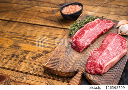 Raw Top blade steak, Fresh Beef shoulder Blade on wooden board. wooden background. top view Raw Top blade steak, Fresh Beef shoulder Blade on wooden board. wooden background. top view 126392709