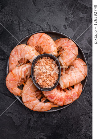Plate with Headless Red Argentine shrimps, Prawns. black background. top view Plate with Headless Red Argentine shrimps, Prawns. black background. top view 126392749