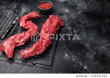 Raw Beef Steak Machete, uncooked meat . black background. top view 126392763
