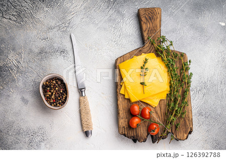 Processed Melted cheese, thin slices for sandwiches. white background. top view Processed Melted cheese, thin slices for sandwiches. white background. top view 126392788