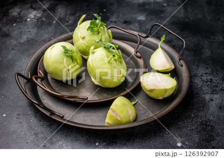 Raw kohlrabi on steel tray, Vegetable from Organic farm. black backround. top view 126392907