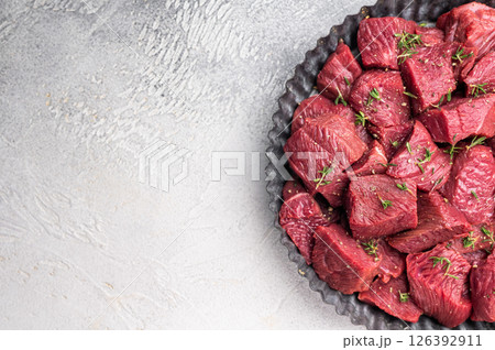 Ready for cooking Diced Raw kangaroo meat. white background. top view Ready for cooking Diced Raw kangaroo meat. white background. top view 126392911