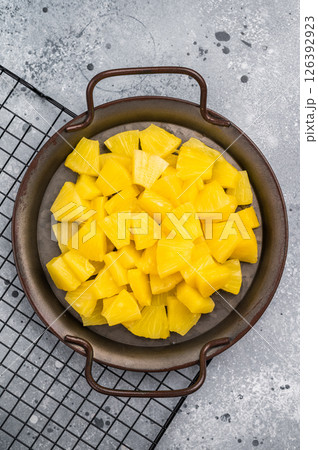 Canned Pineapple chunks slices in a bowl. grey background. top view 126392923
