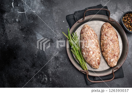 Freshly prepared raw Kofta kebab, marinated with spices, ready for grilling and bursting with flavor. black background. top view 126393037
