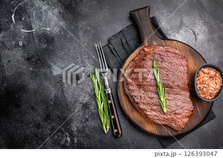 Grilled Flank Flap beef steak, showcasing beautiful grill marks. black background. top view Grilled Flank Flap beef steak, showcasing beautiful grill marks. black background. top view 126393047