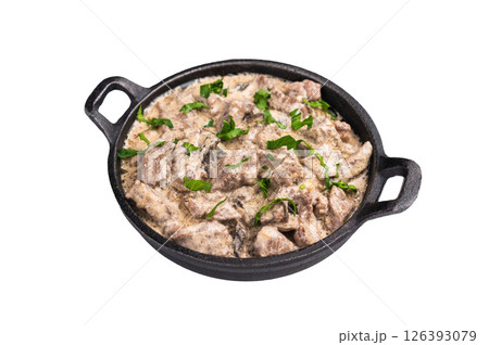 Creamy beef stroganoff with fresh greenery in a skillet isolated on white background. top view Creamy beef stroganoff with fresh greenery in a skillet isolated on white background. top view 126393079
