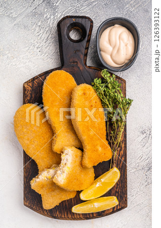 Deep fried Fish fingers on wooden board. white background. top view Deep fried Fish fingers on wooden board. white background. top view 126393122