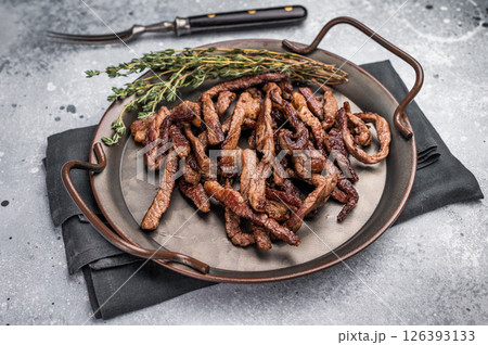 Deep fried beef tender strips, sliced meat in a tray. grey background. top view Deep fried beef tender strips, sliced meat in a tray. grey background. top view 126393133