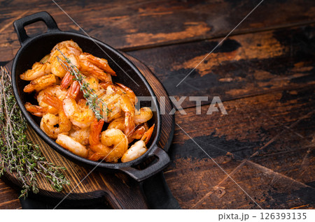 Deliciously seasoned grilled shrimp prawns with vibrant colors, a must-have for seafood lovers and culinary enthusiasts. wooden background. top view 126393135