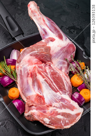 High quality raw goat shoulder leg, an essential ingredient for hearty stews and savory dishes. black background. top view 126393138