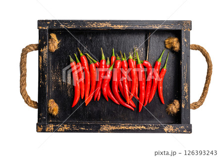 Red hot chili peppers on wooden board isolated on white background. top view 126393243