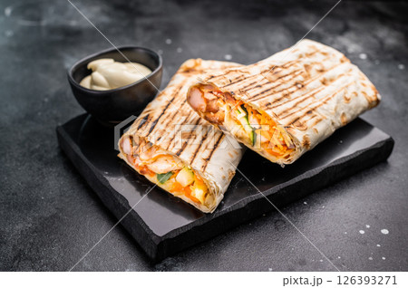 Oriental Doner kebab wrap, Shawarma with beef meat and salad. black background. top view Oriental Doner kebab wrap, Shawarma with beef meat and salad. black background. top view 126393271
