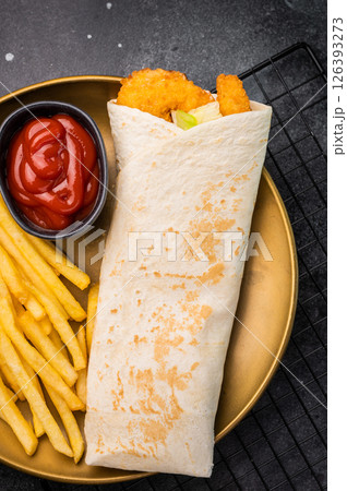 Doner kebab with shrimps, prawns, salad and french fry. black background. top view Doner kebab with shrimps, prawns, salad and french fry. black background. top view 126393273