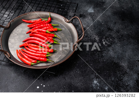 Hot Red chili peppers in a steel tray isolated on white background. top view 126393282