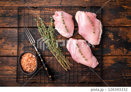 Raw Skinless boneless chicken thighs fillet. wooden background. top view Raw Skinless boneless chicken thighs fillet. wooden background. top view 126393332