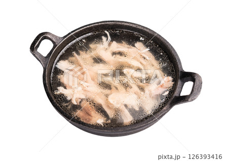 Chicken broth with meat in a skillet isolated on white background. top view 126393416