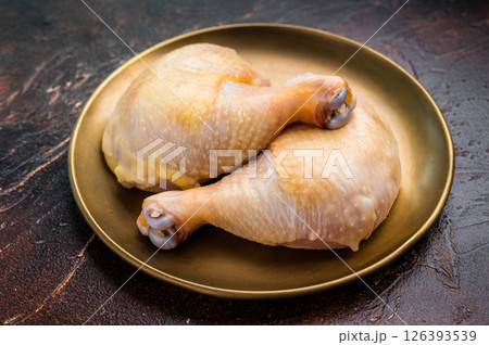 Chicken legs, raw poultry meat on black background, top view Chicken legs, raw poultry meat on black background, top view 126393539