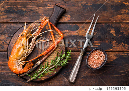 Juicy grilled giant river prawn shrimp served with rosemary, a mouthwatering dish for your next barbecue. wooden background. top view Juicy grilled giant river prawn shrimp served with rosemary, a mouthwatering dish for your next barbecue. wooden background. top view 126393596
