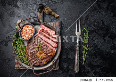 Grilled Rib eye prime steak, roasterd dry aged beef meat. black background. top view 126393600