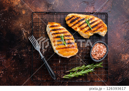 Eco Chicken grilled breasts, roasted poultry farm meat, top view, brown background. Eco Chicken grilled breasts, roasted poultry farm meat, top view, brown background. 126393617