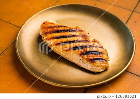 Grilled Chicken breast steak on a plate, fried poultry meat, top view. Grilled Chicken breast steak on a plate, fried poultry meat, top view. 126393621